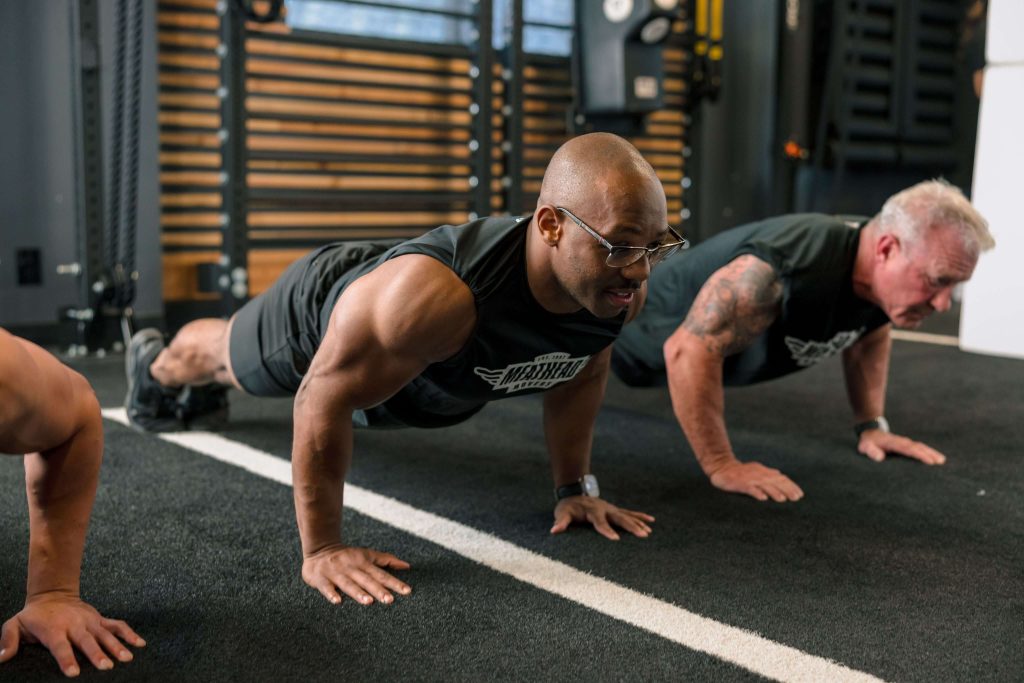 Meathead Movers athletes doing push-ups together in the gym