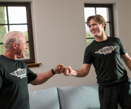 Meathead mover sharing a fist bump with a smiling customer