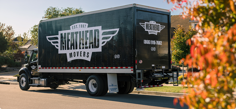 Meathead Movers truck parked on a tree-lined street