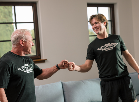 Meathead mover sharing a fist bump with a smiling customer