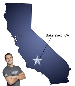An arrow pointing to the city of Bakersfield on a map of California with an athletic Meathead Mover standing happily next to the state.
