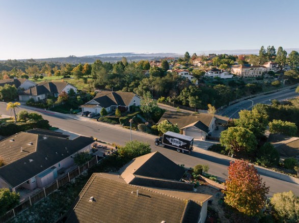 Aerial view of a Meathead Movers truck driving through a Bay Area neighborhood