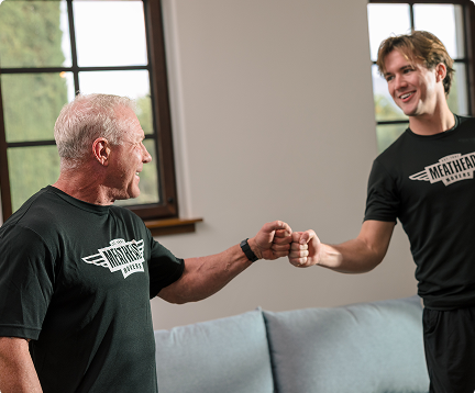 Meathead mover sharing a fist bump with a smiling customer